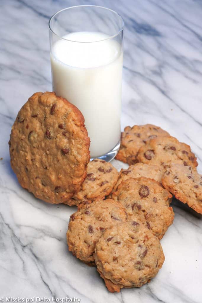chocolate chip coconut pecan cookies with a glass of milk