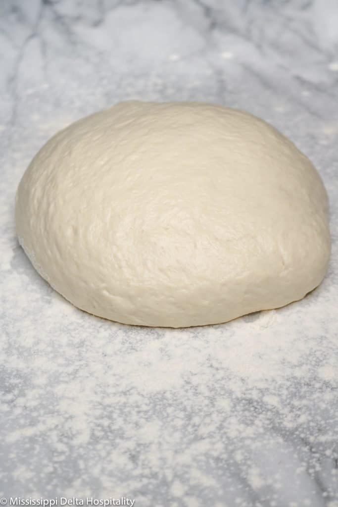 ball of pizza dough on marble board