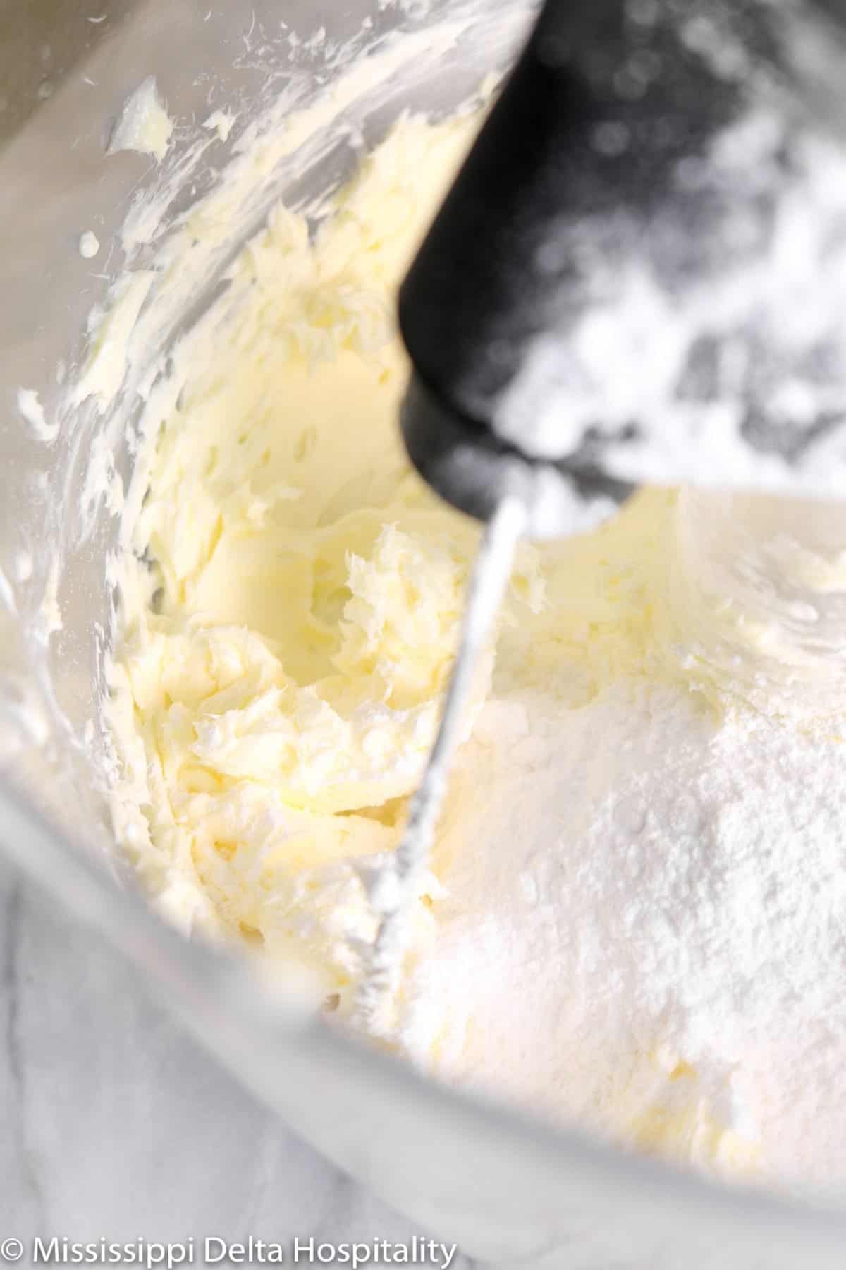 powdered sugar being added to butter