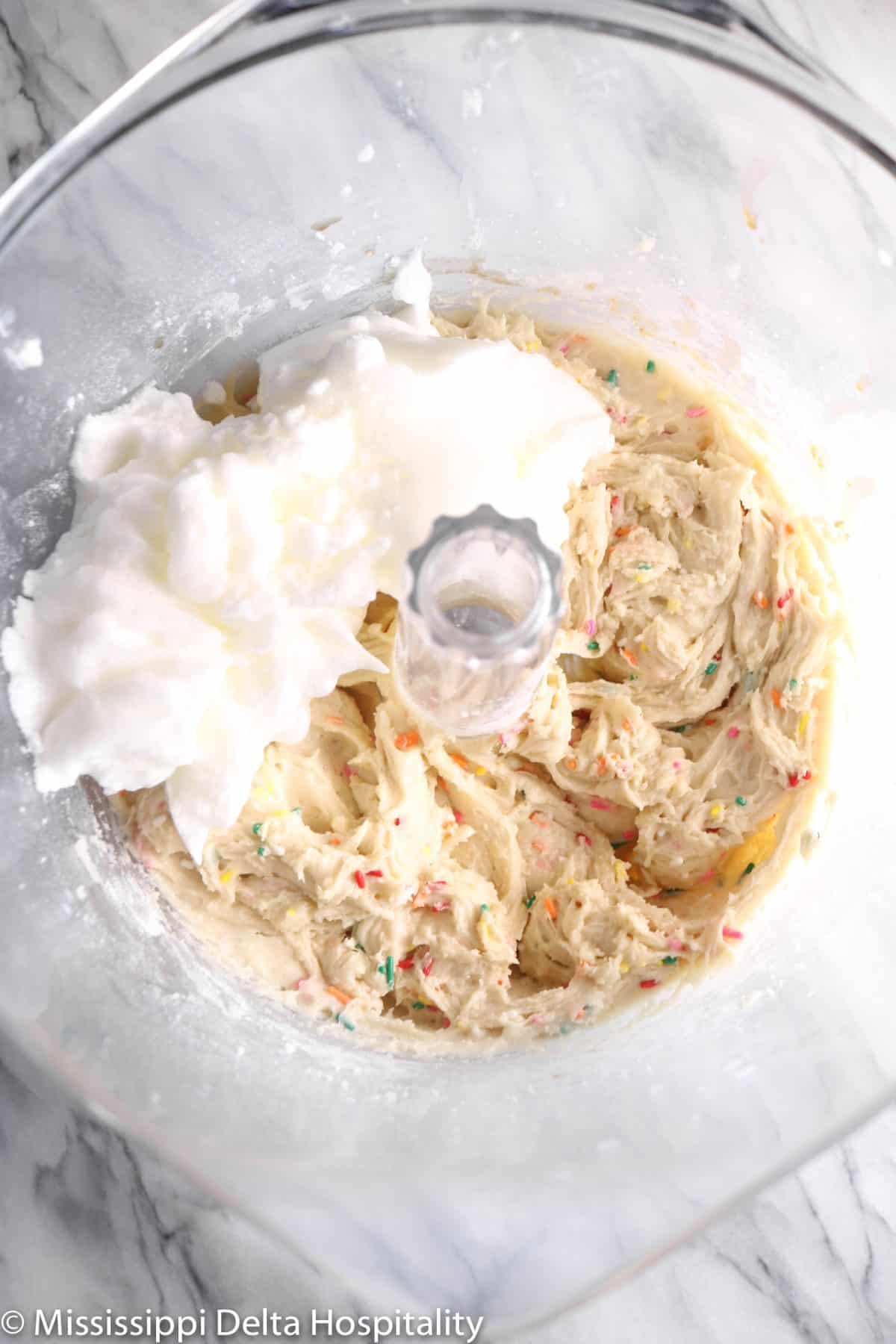 egg whites and cake batter in a mixer 
