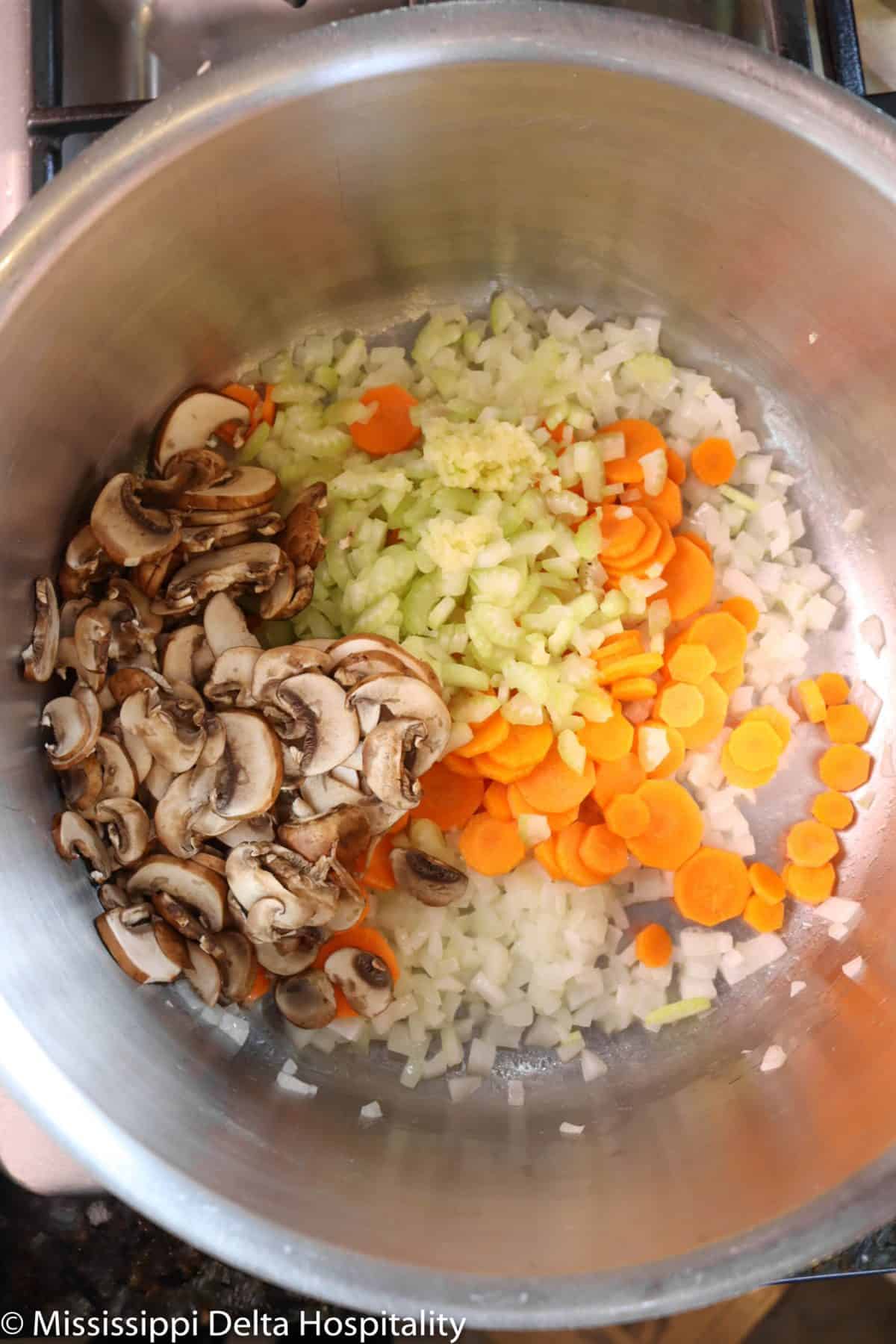 chopped onions, carrots, mushrooms, celery, and garlic in a stock pot