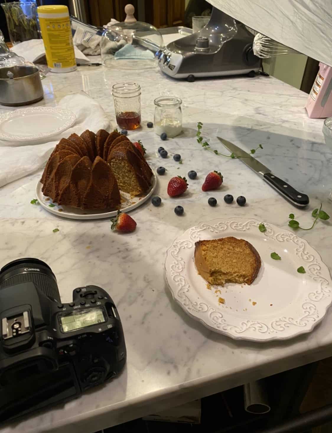 bundt cake on a marble board with a camera