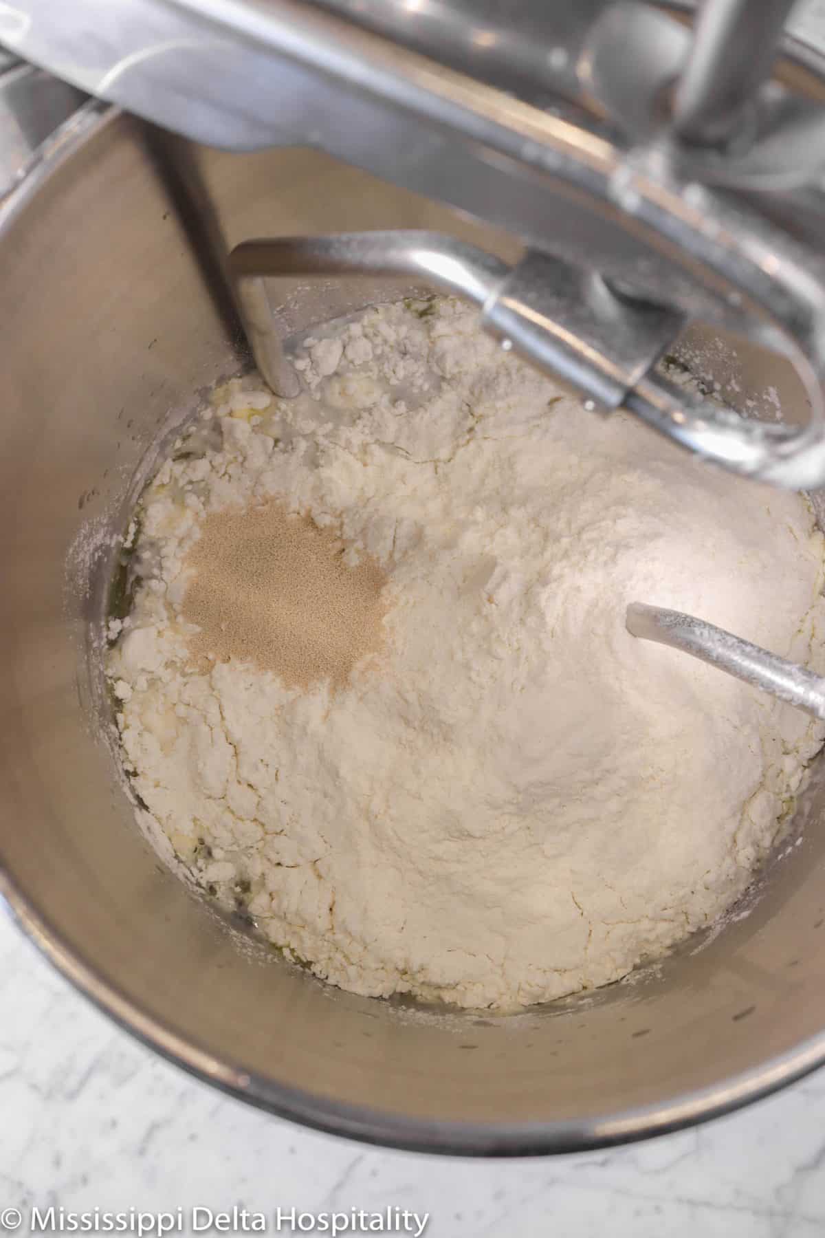 flour and yeast added to water and oil mixture
