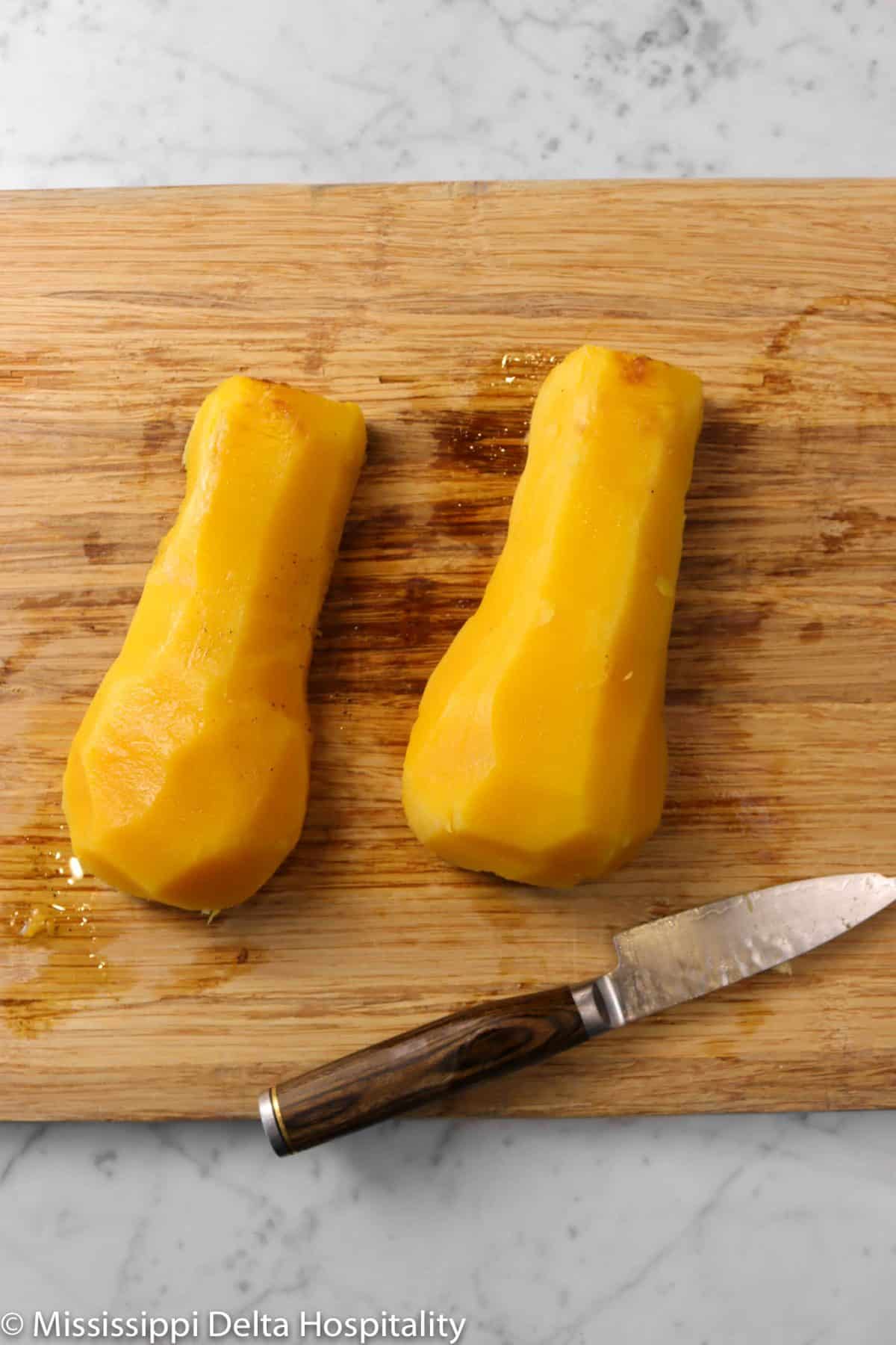 two halves of butternut squash peeled
