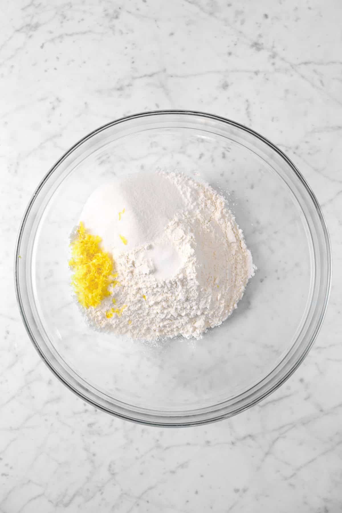flour, sugar, baking powder, and lemon zest in a glass bowl