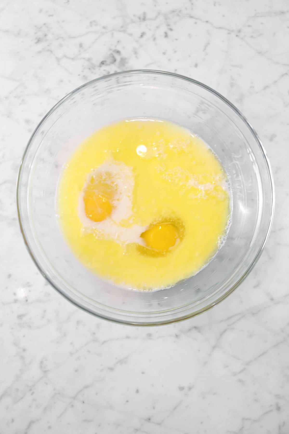 milk, butter, and eggs in a glass bowl