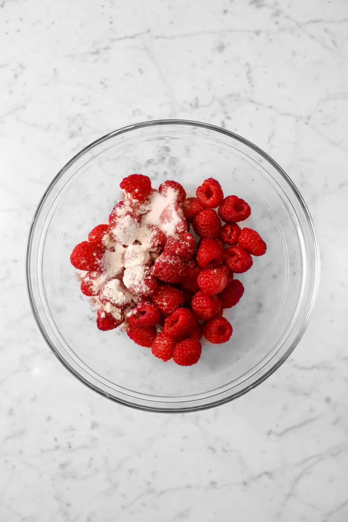 raspberries, flour, and sugar in a bowl