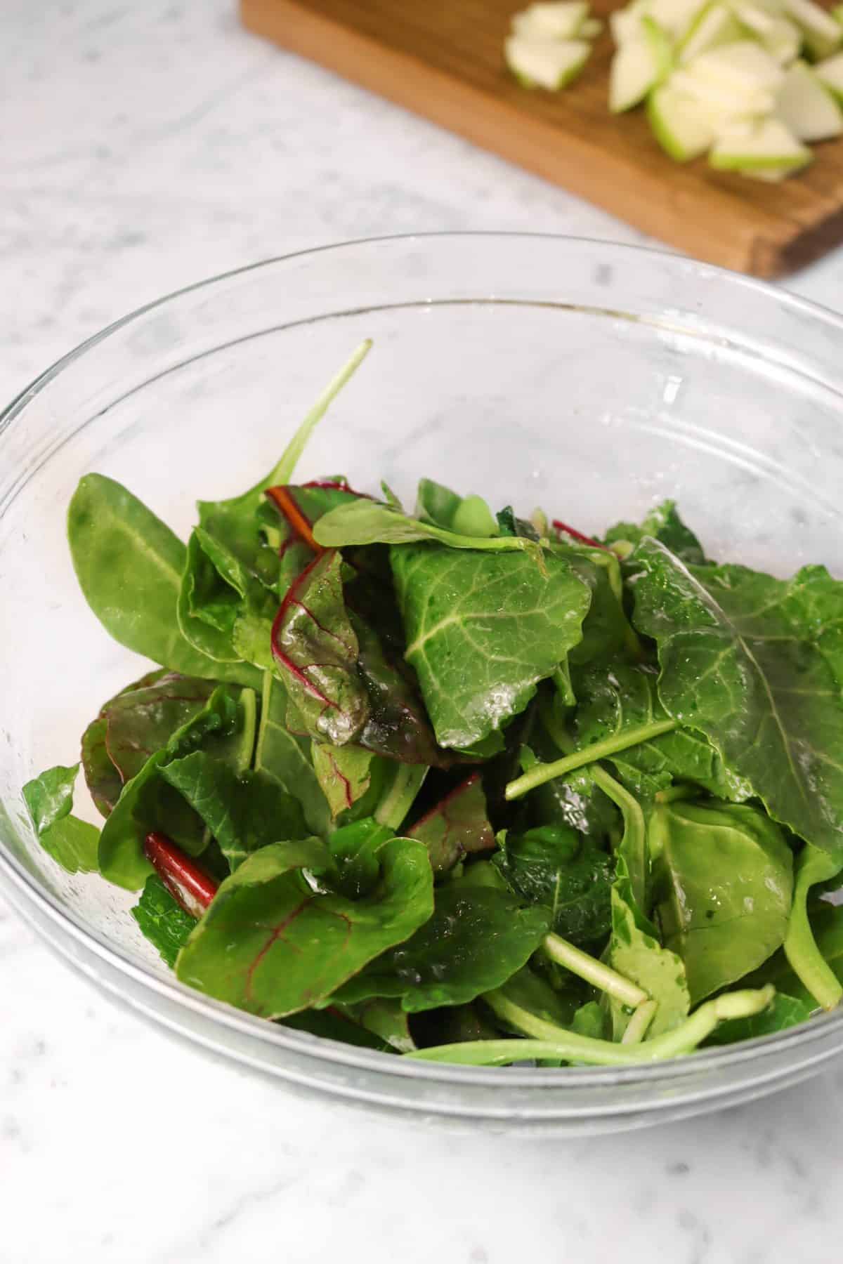 salad greens tossed together with red wine vinegar and olive oil 
