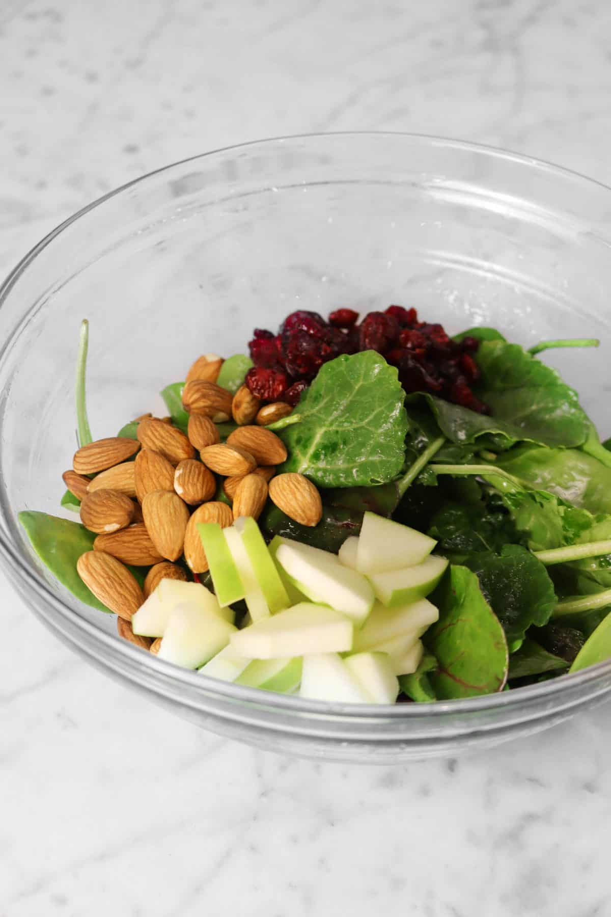 almonds, cranberries, and apples added to greens