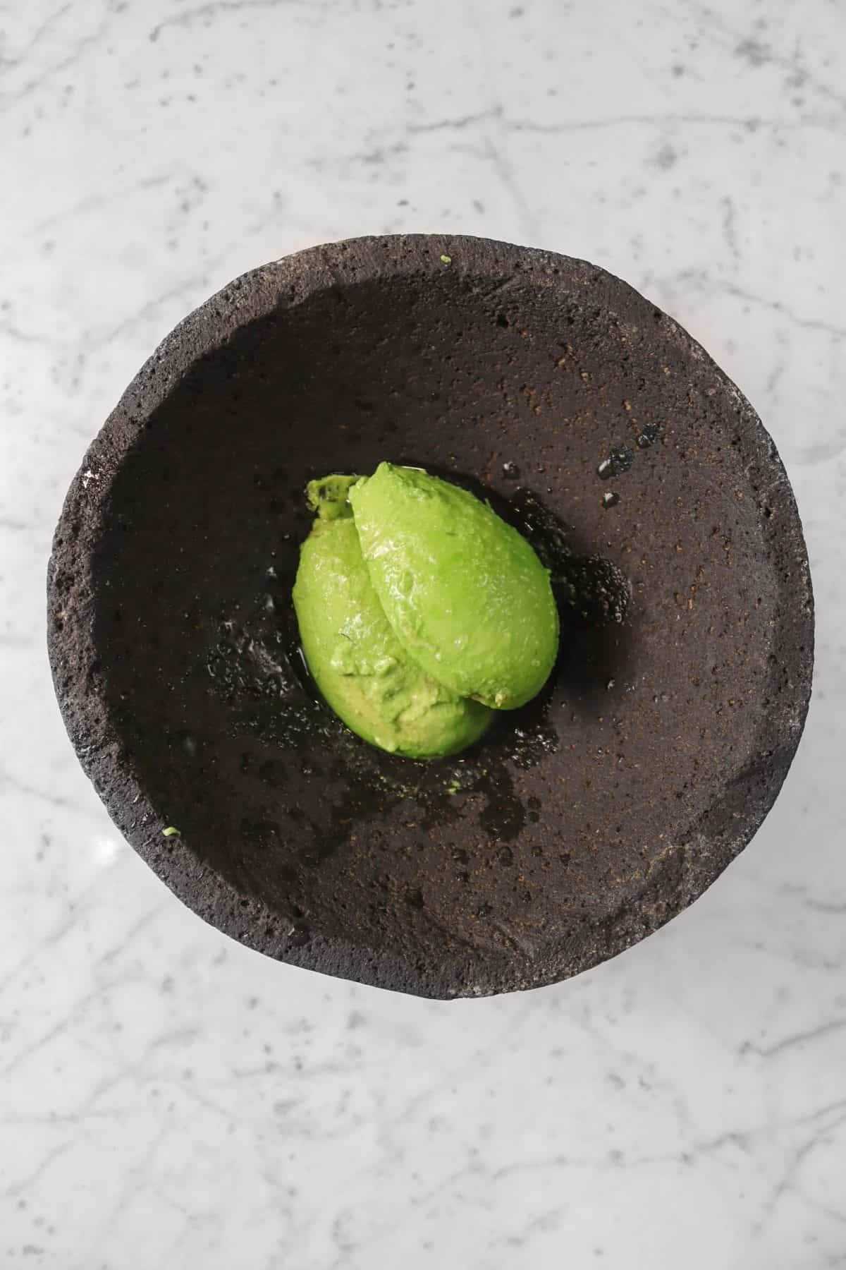 avocado and lime juice in a molcajete