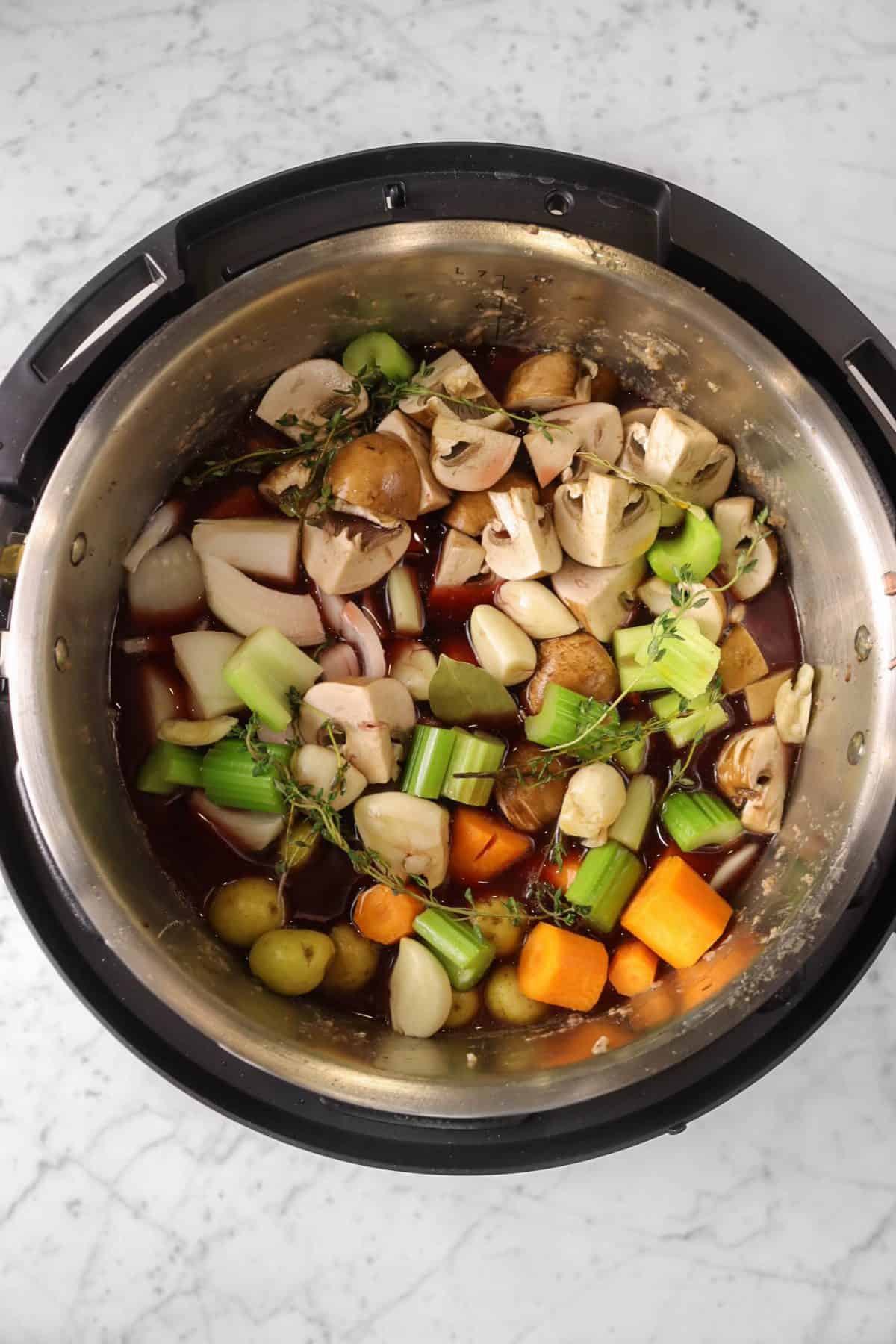 vegetables and beef stock and wine added to instant pot 