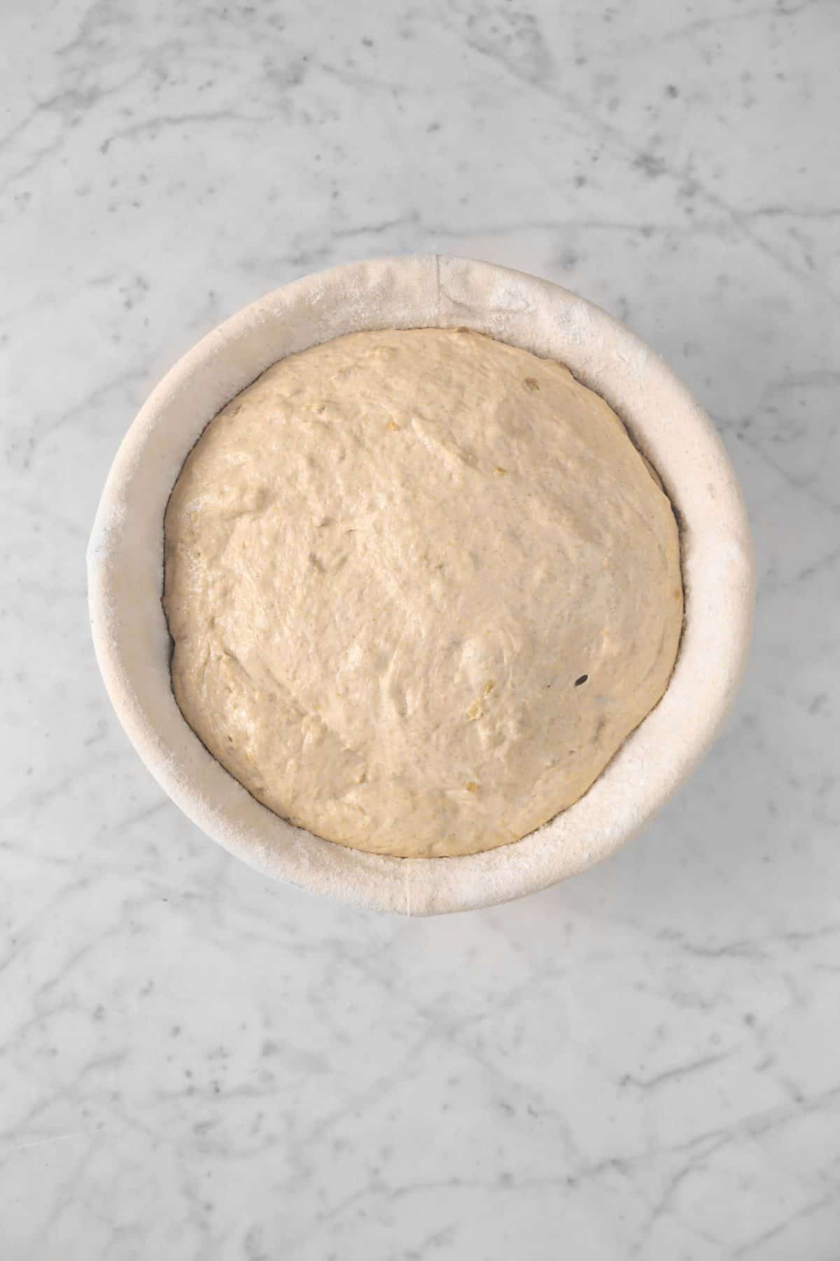 dough doubled in bulk in a banneton