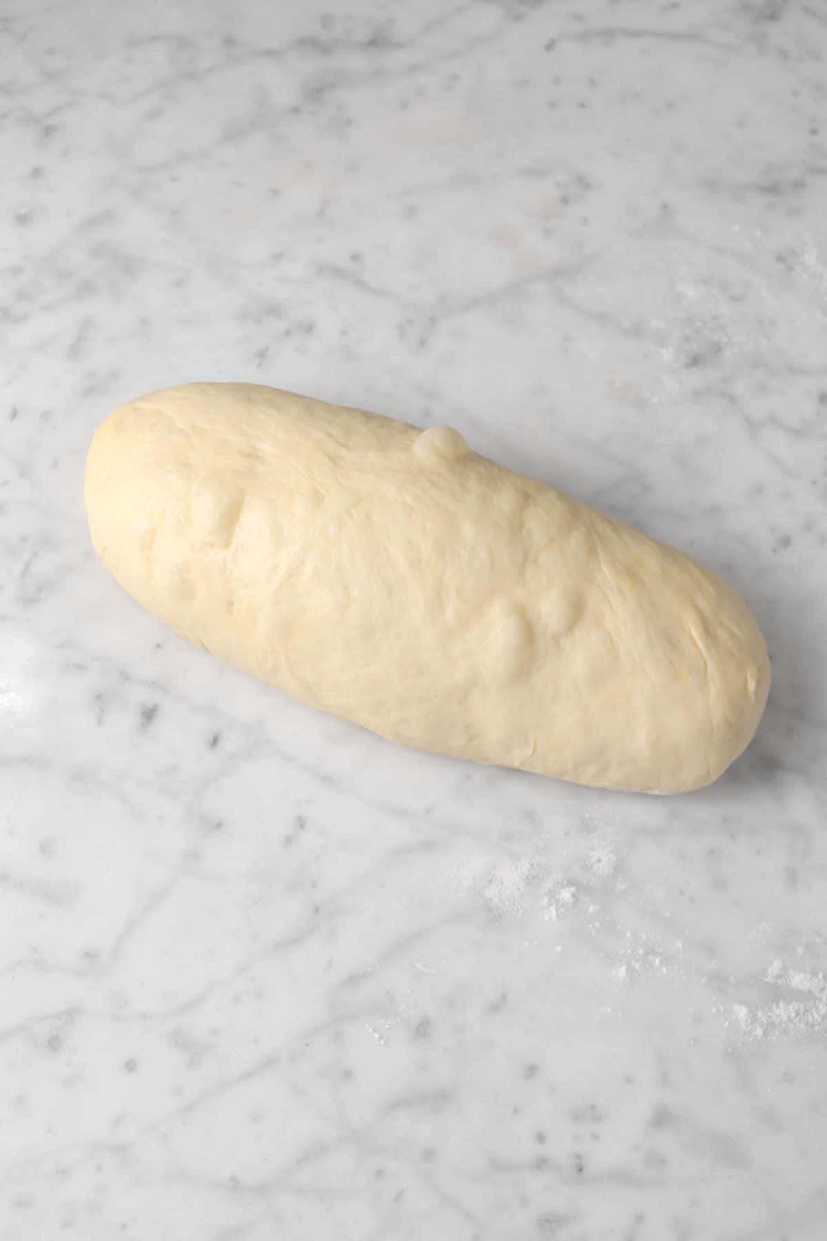 dough shaped on a marble counter