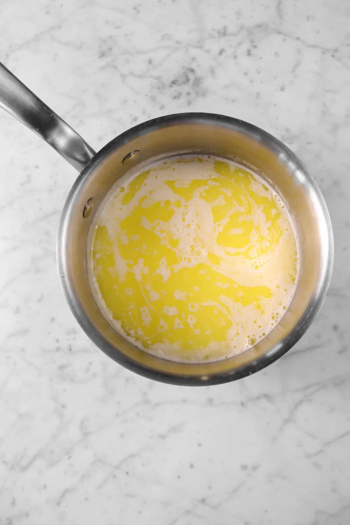 milk added to melted butter in a small pot