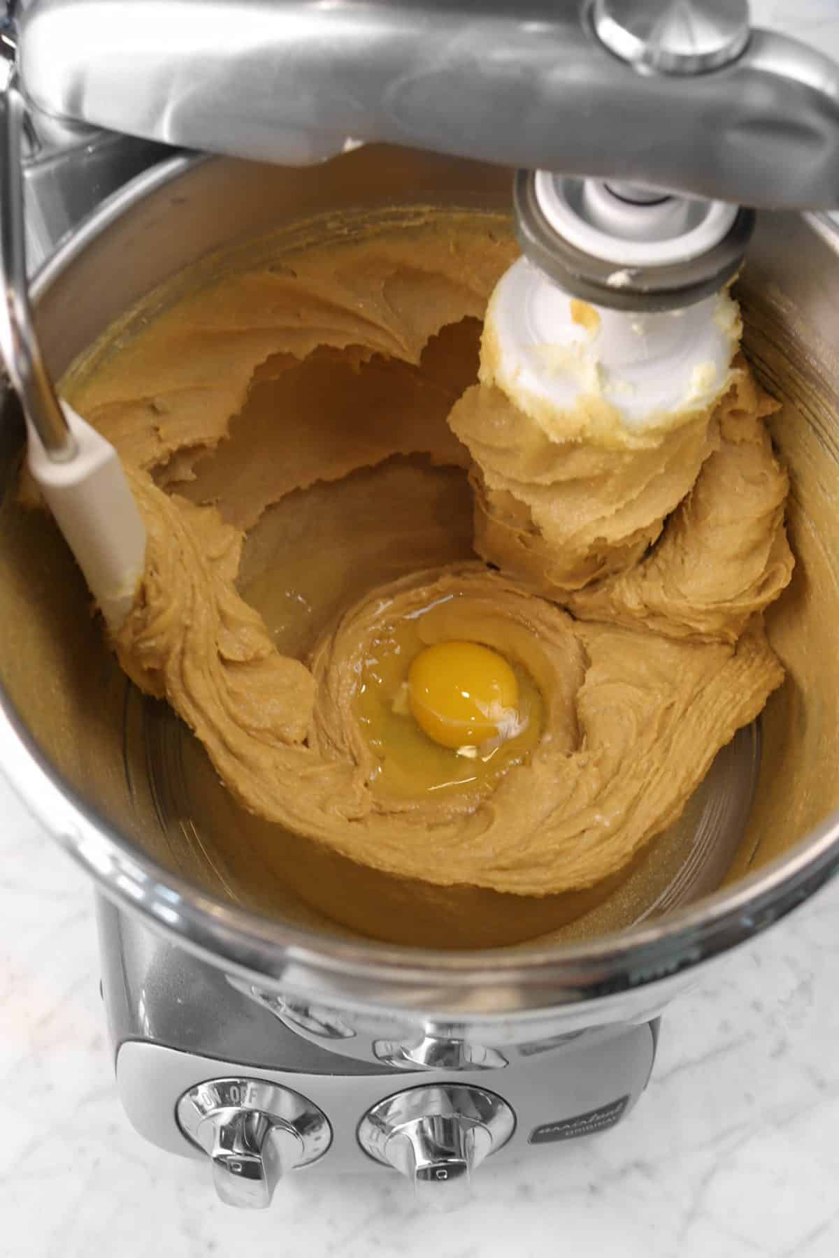 egg added to peanut butter mixture in a mixing bowl
