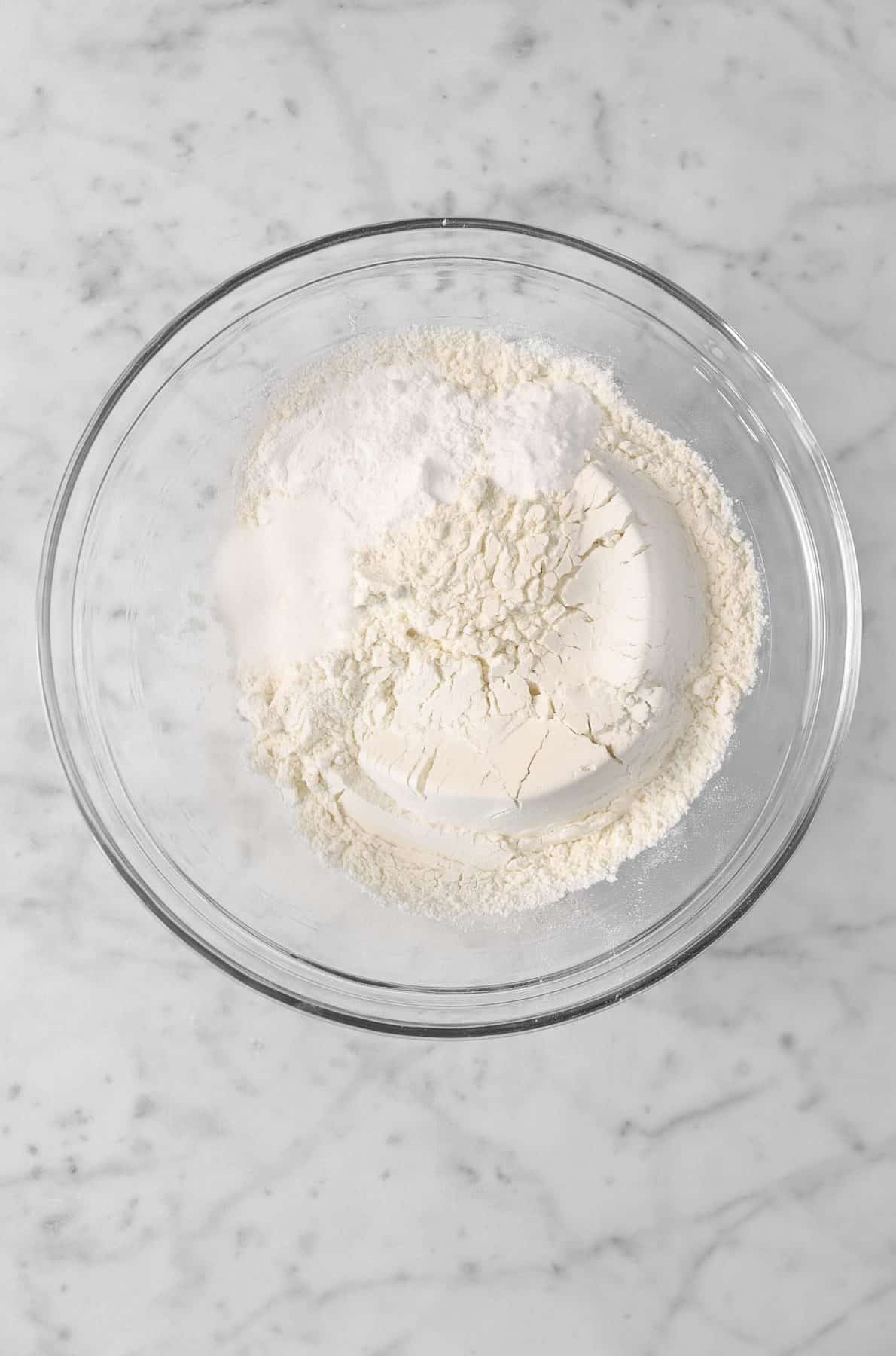 flour, baking powder, baking soda, and salt in a glass bowl