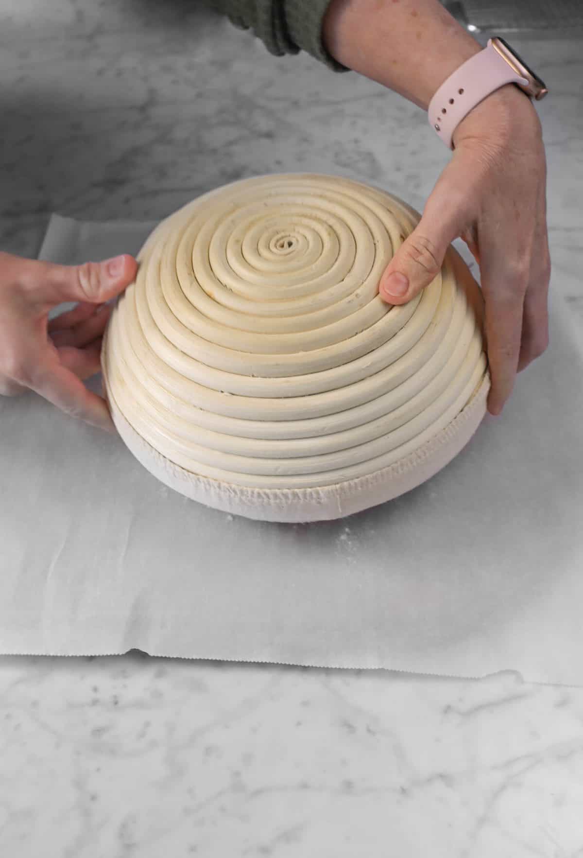 dough being turned out onto a piece of parchment