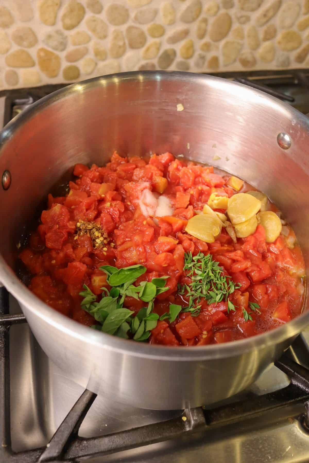 ingredients for tomato soup in a small stock pot