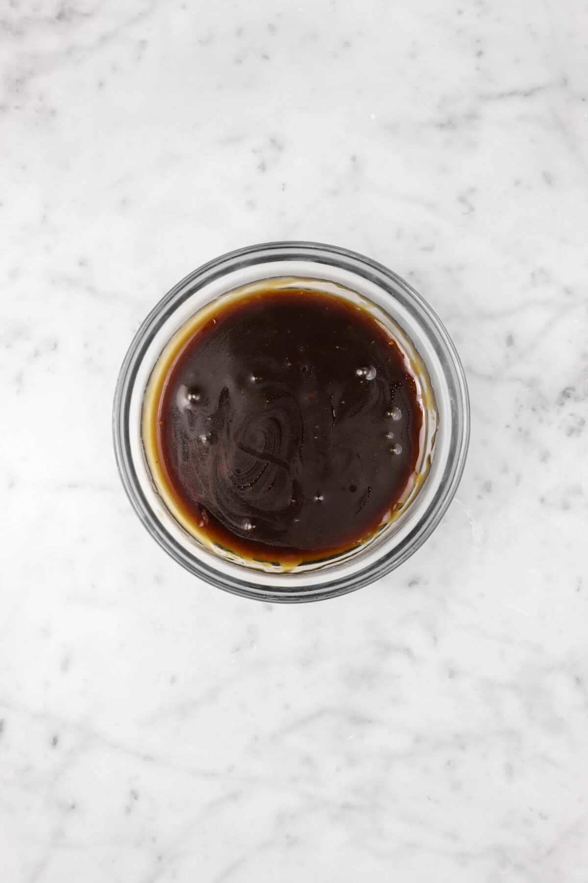 balsamic vinaigrette in a glass bowl on a marble counter