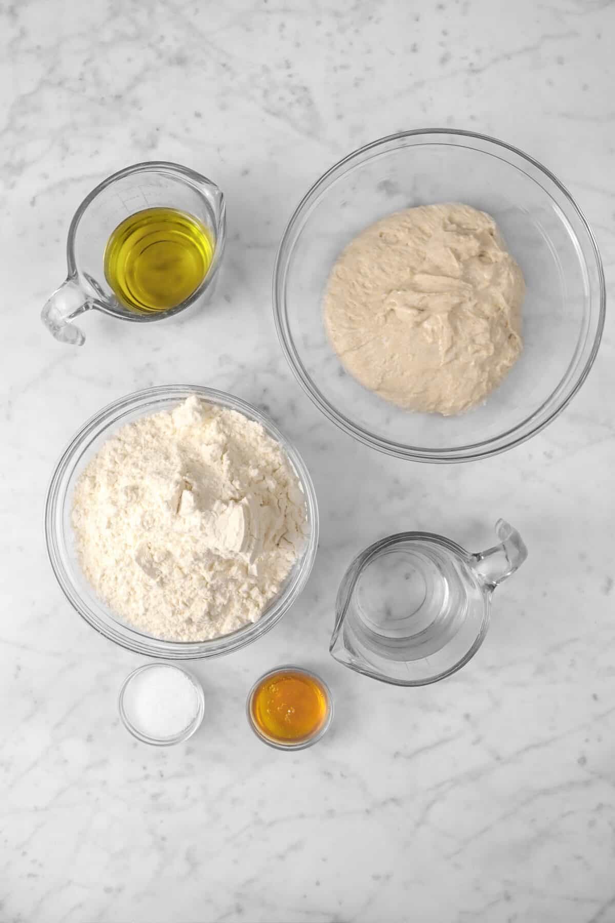 ingredients for sourdough pizza crust on a marble counter