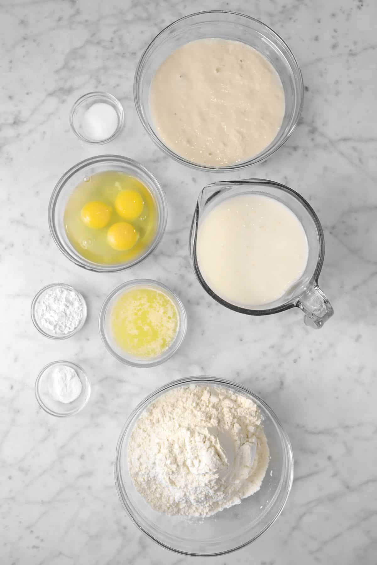 ingredients for sourdough waffles on a marble counter top