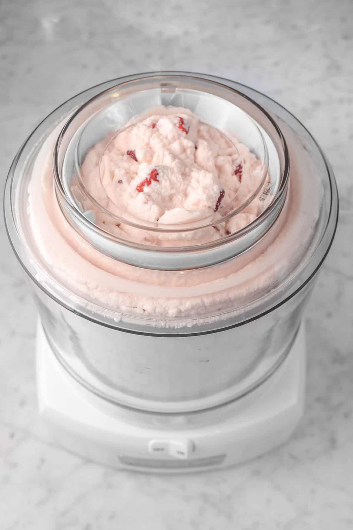 strawberry ice cream in a white ice cream maker