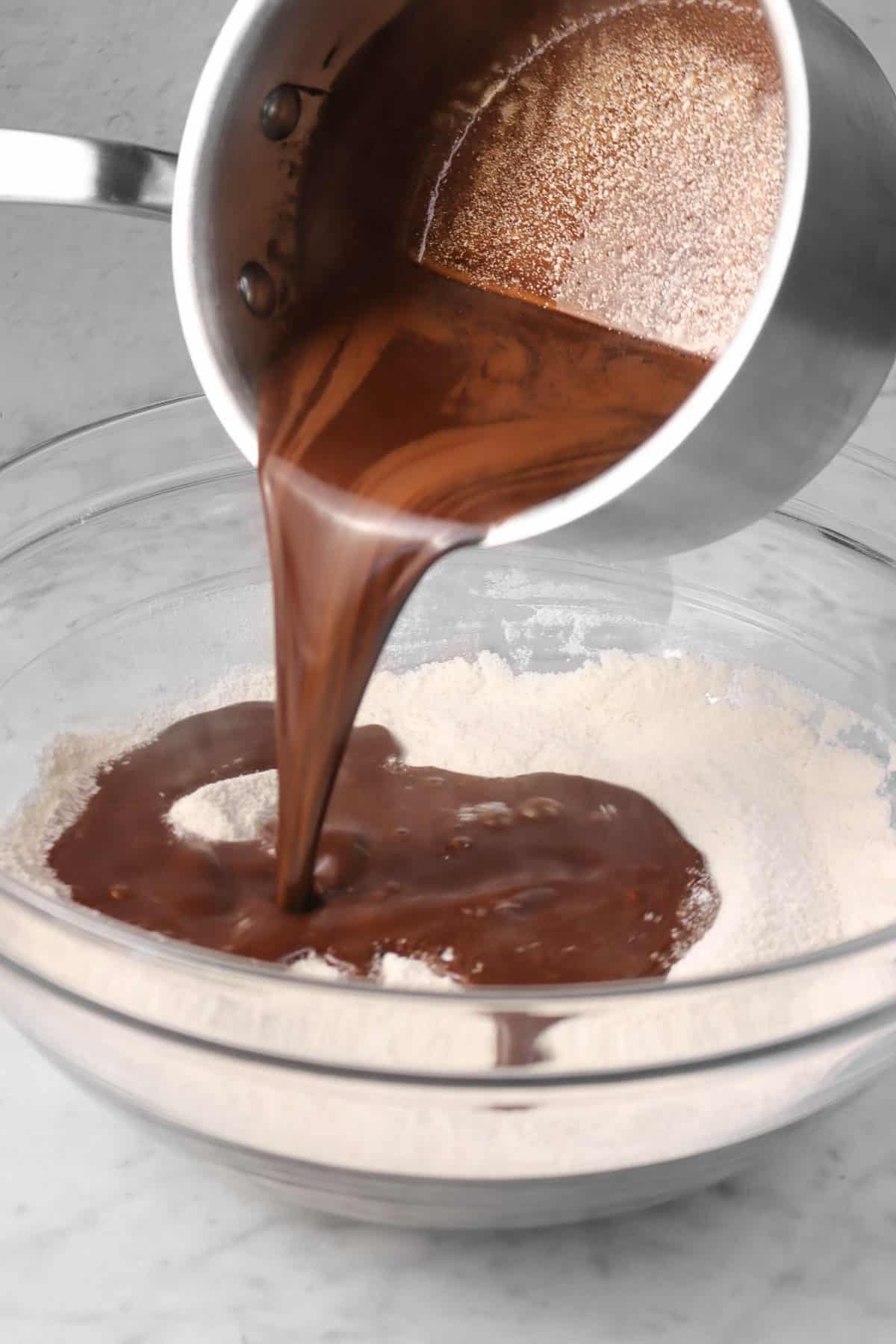 chocolate mixture being poured into dry ingredients