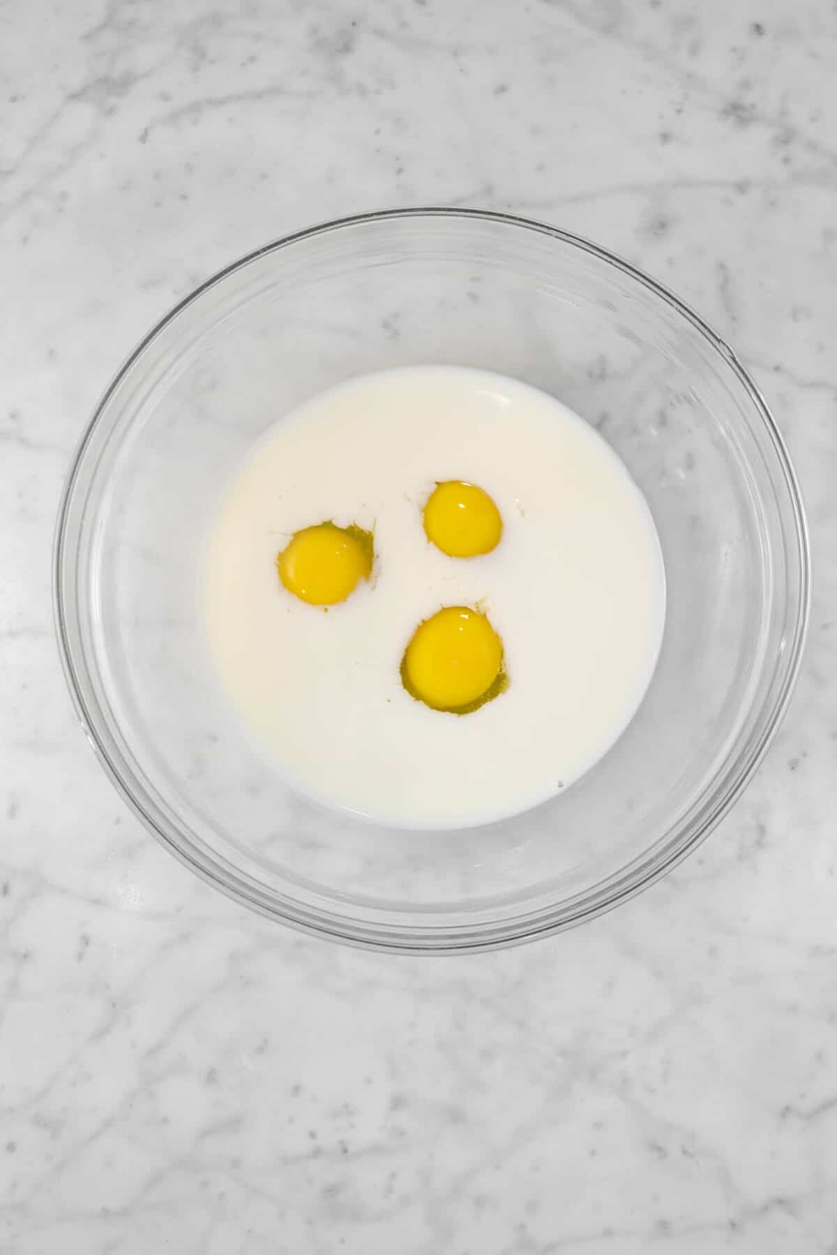 milk and eggs in a bowl