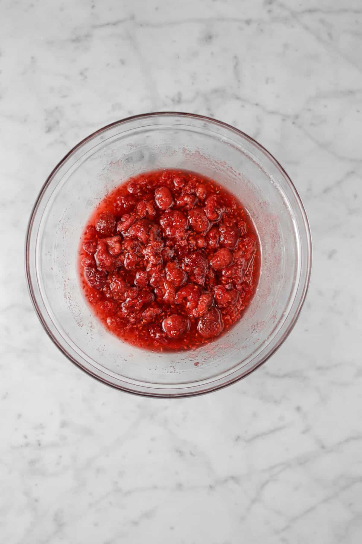macerated raspberries in a glass bowl