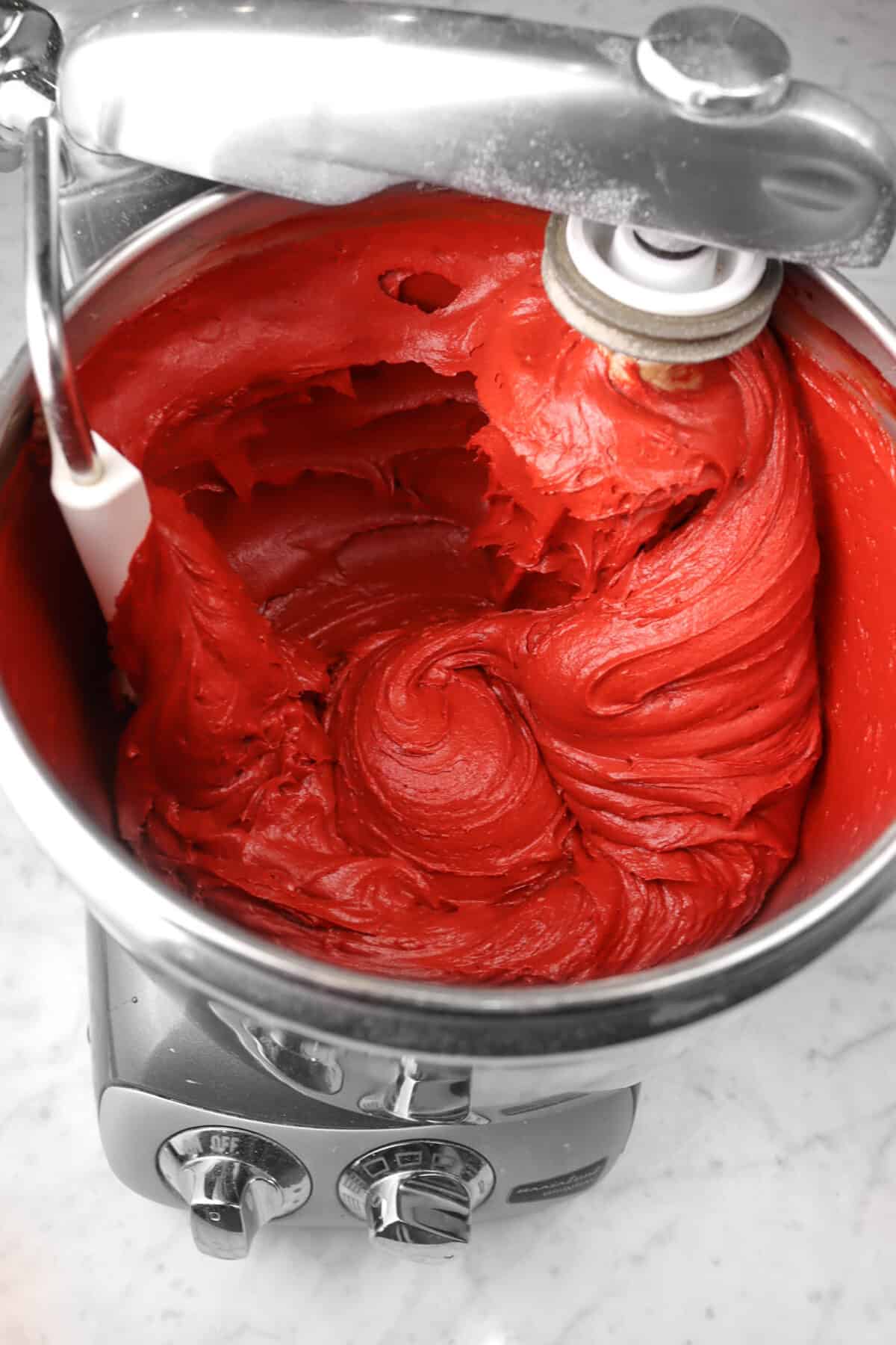 red velvet cake batter in a mixer bowl