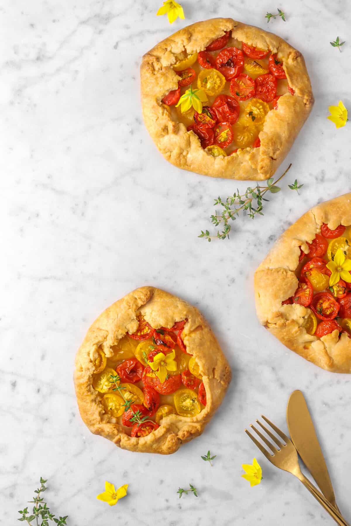 two and a half galettes on marble with thyme and flowers