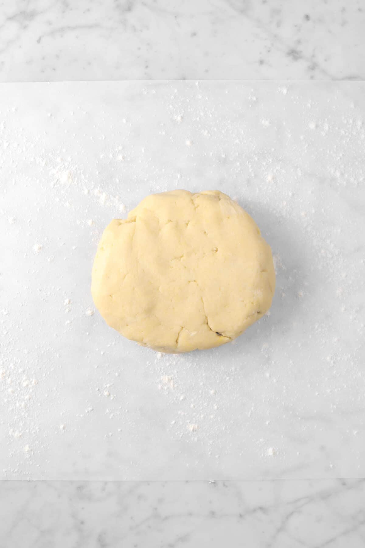 pie dough disc on a piece of parchment paper