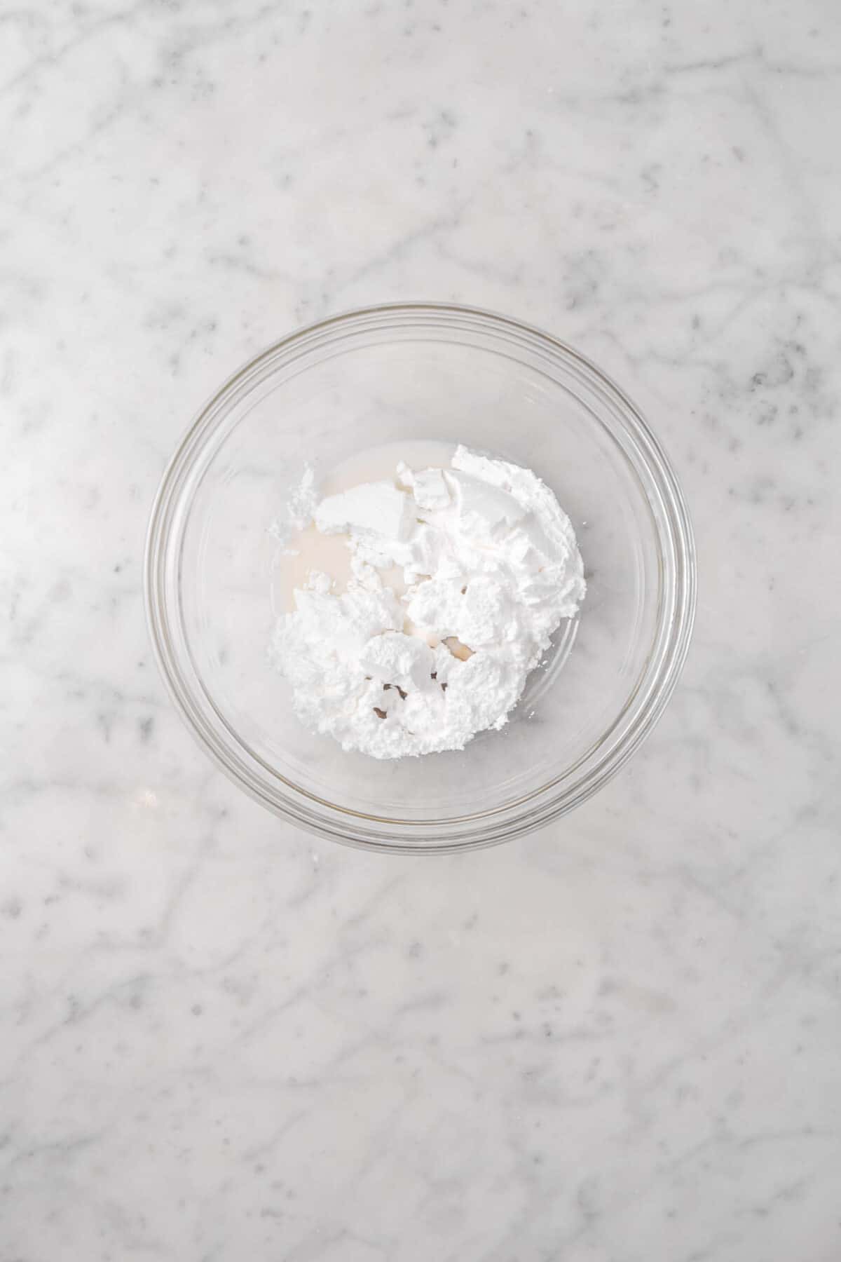 cream, vanilla, and powdered sugar in a bowl