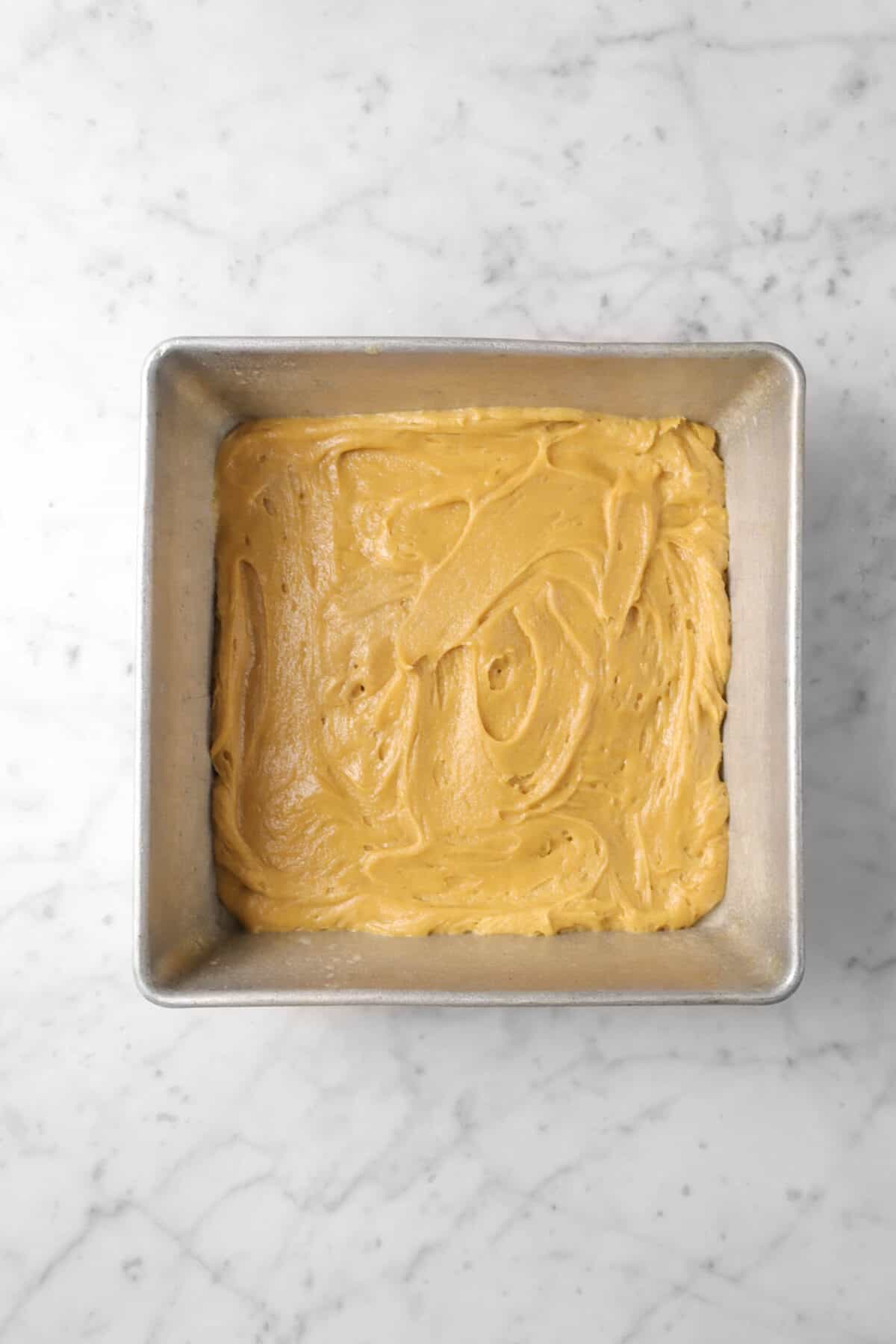 peanut butter brownie batter in square pan