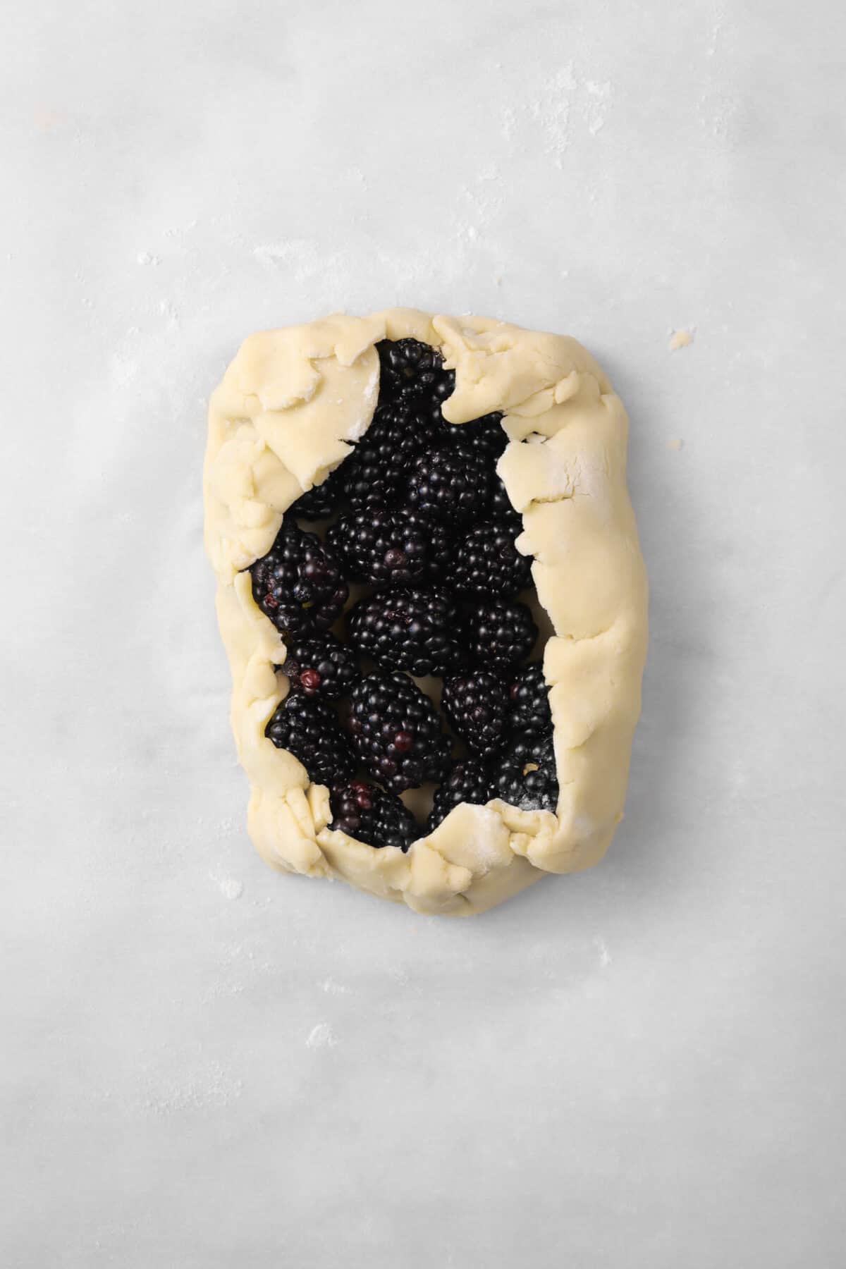 pastry dough folded up over blackberries