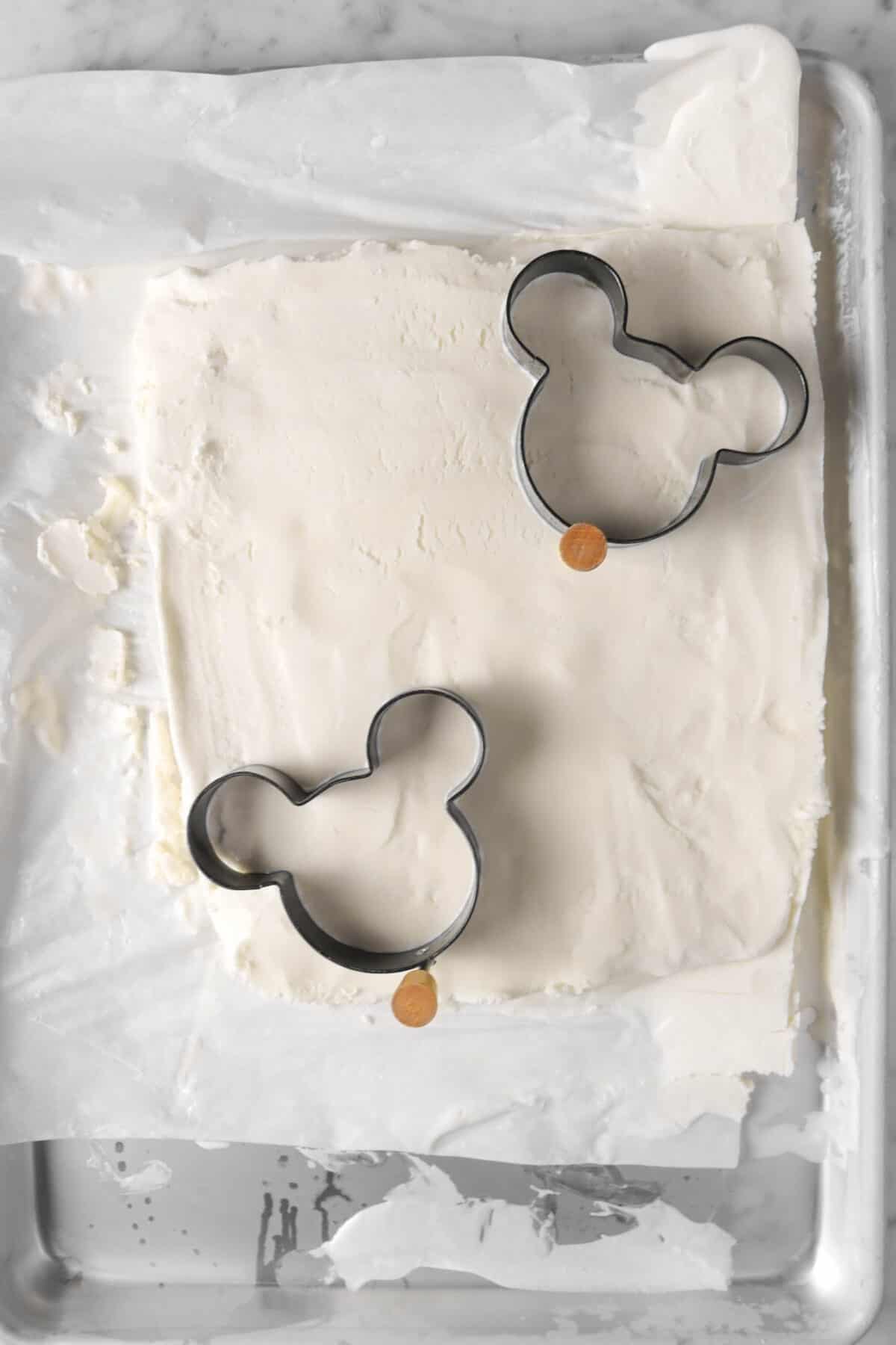 two mickey shaped cutters on vanilla ice cream