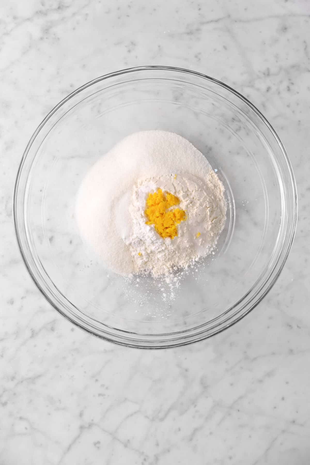 orange zest, sugar, flour, and baking powder in a bowl