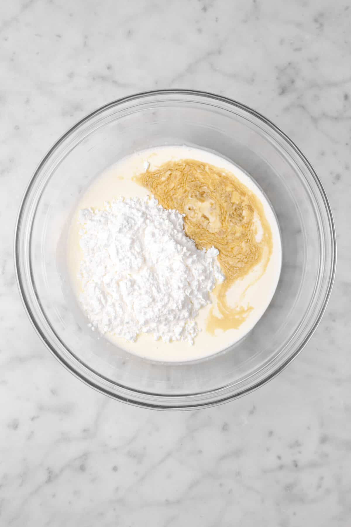 heavy cream, powdered sugar, and vanilla in a glass bowl