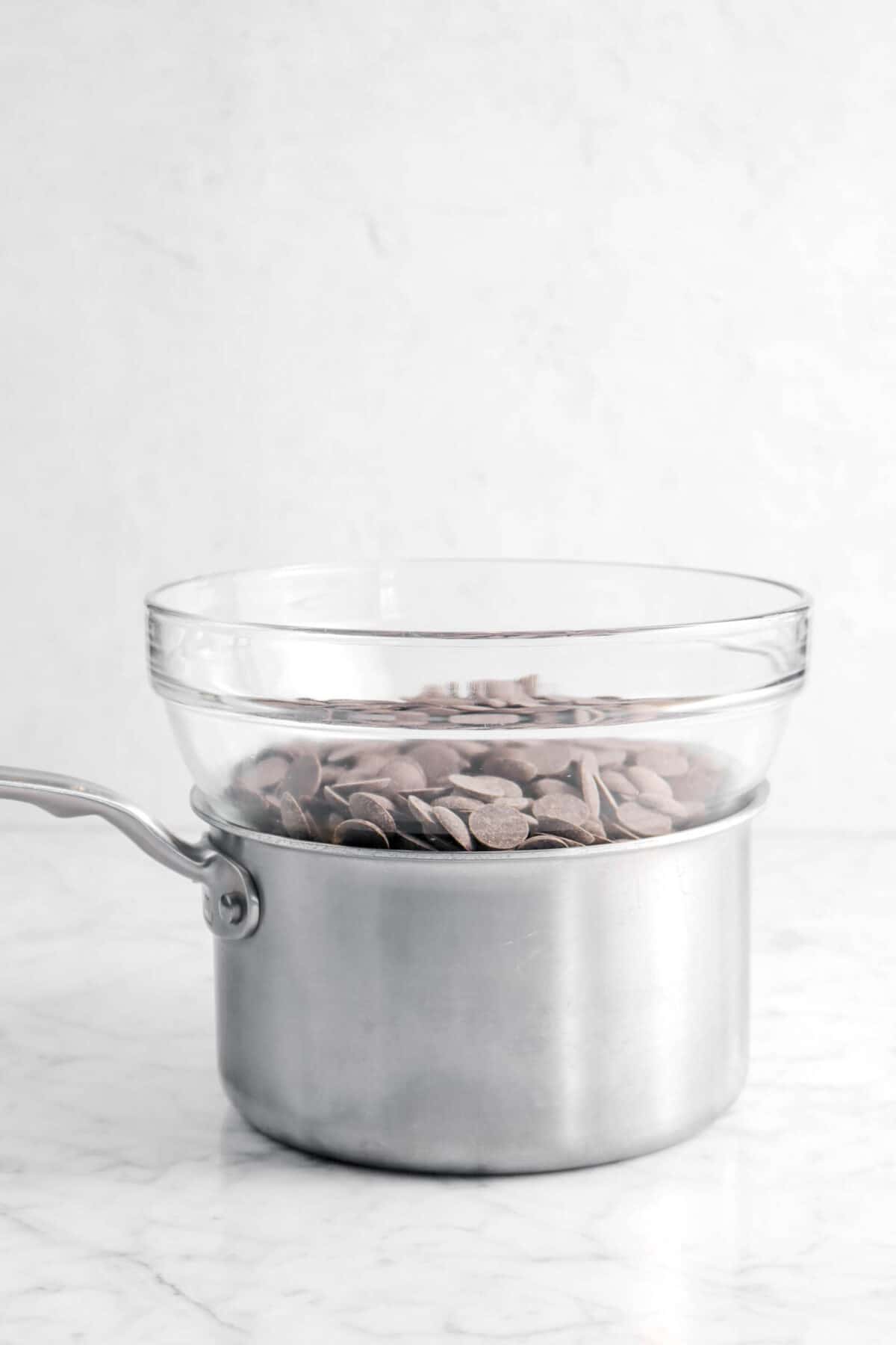 chocolate in a glass bowl on a small pot