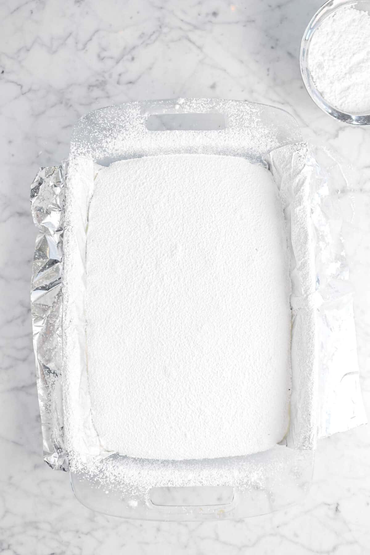 powdered sugar sifted on top of marshmallow mixture