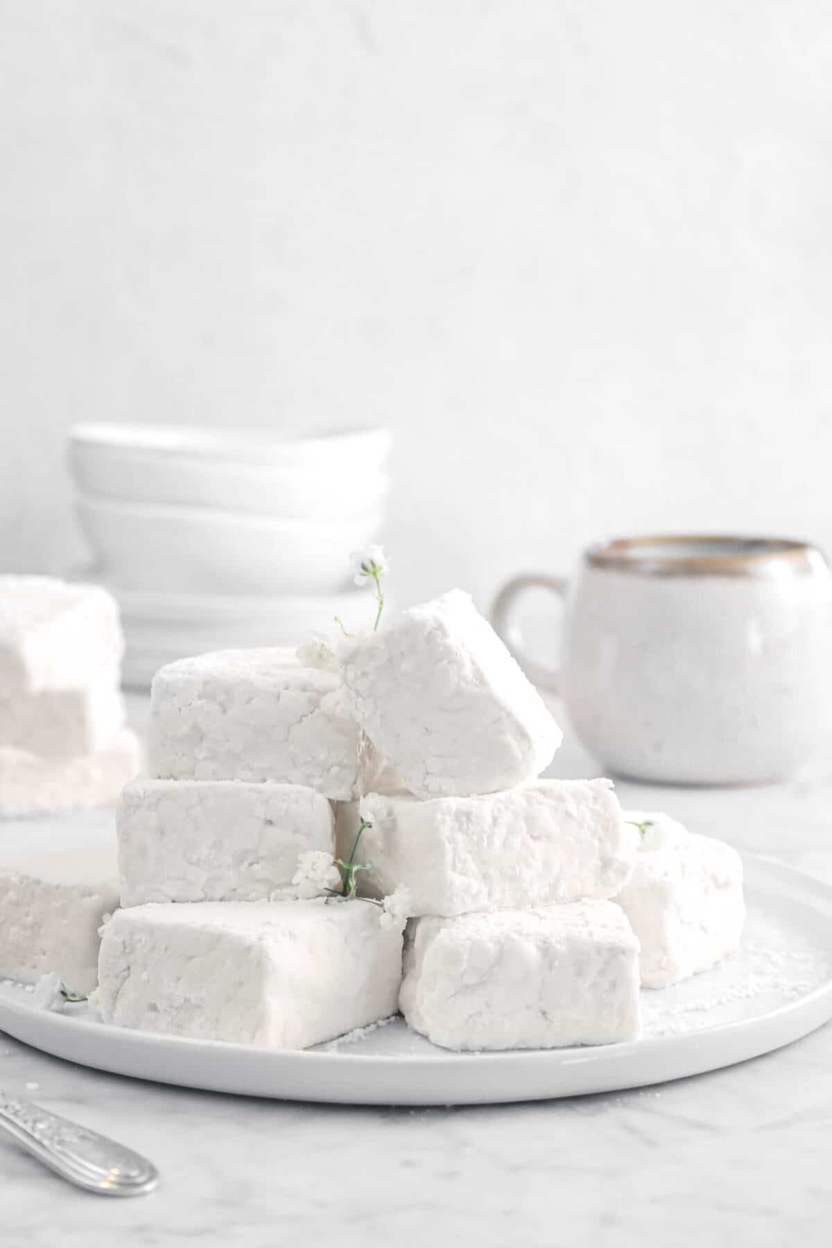 marshmallows stacked on a white plate with flowers