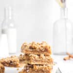three apple pie crumble bars stacked on wire cooling rack