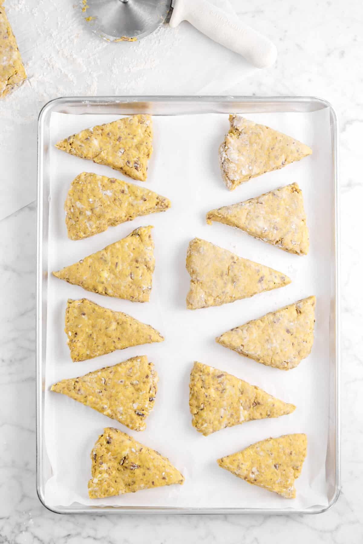 twelve scones on a lined baking sheet