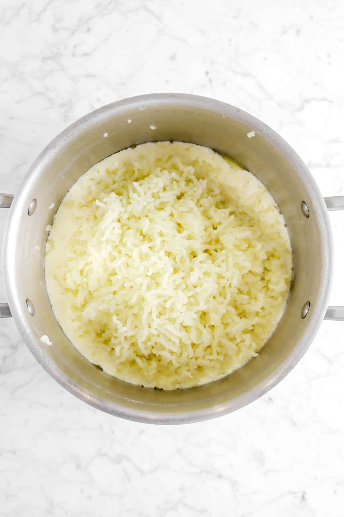 mashed potatoes in pot with cream and butter
