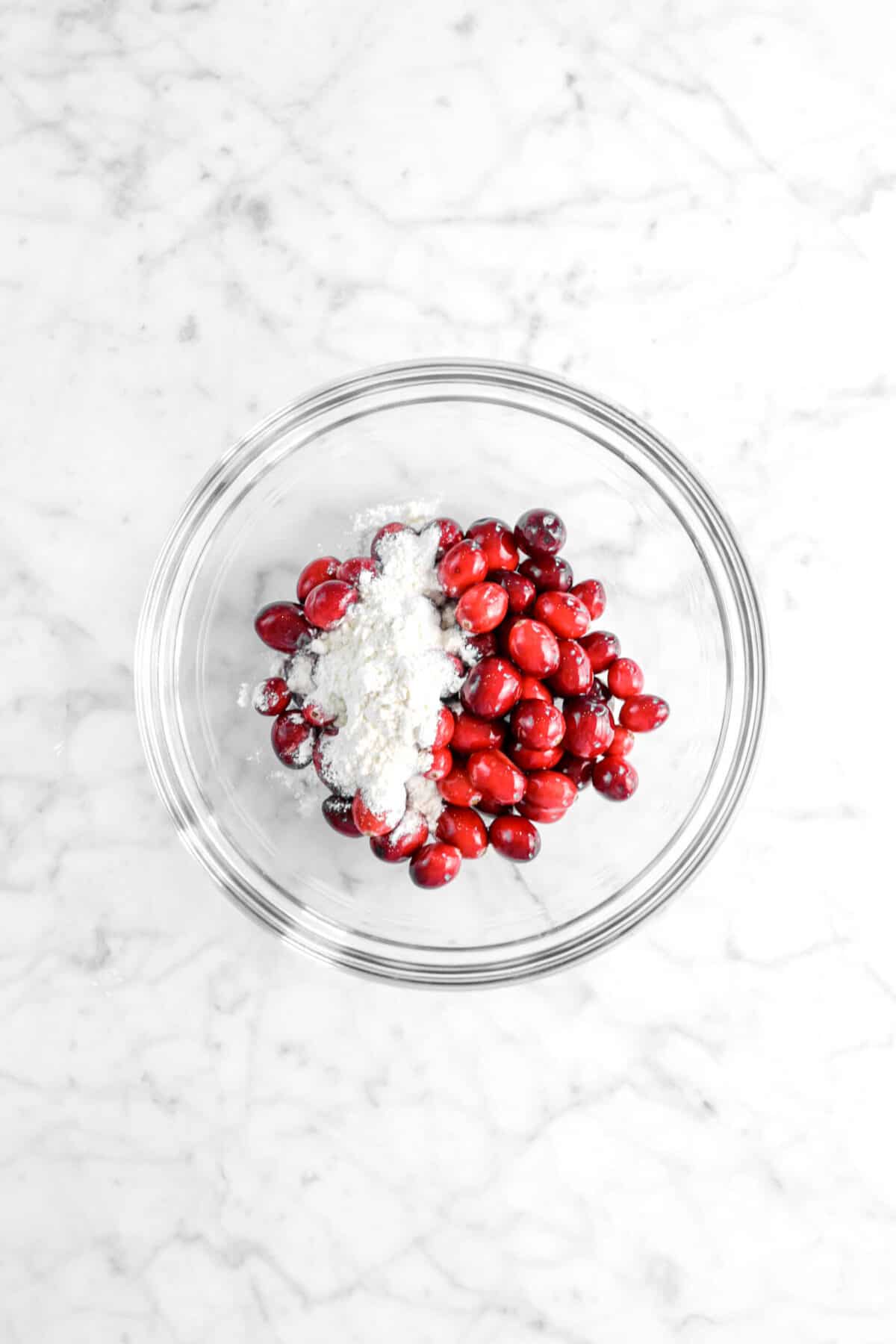 flour and cranberries in a glass bowl