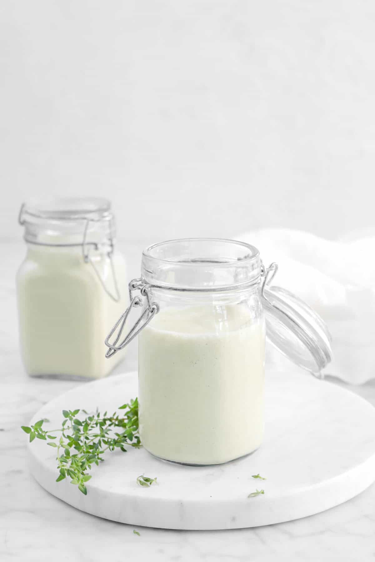 cream of celery soup in two jars with thyme