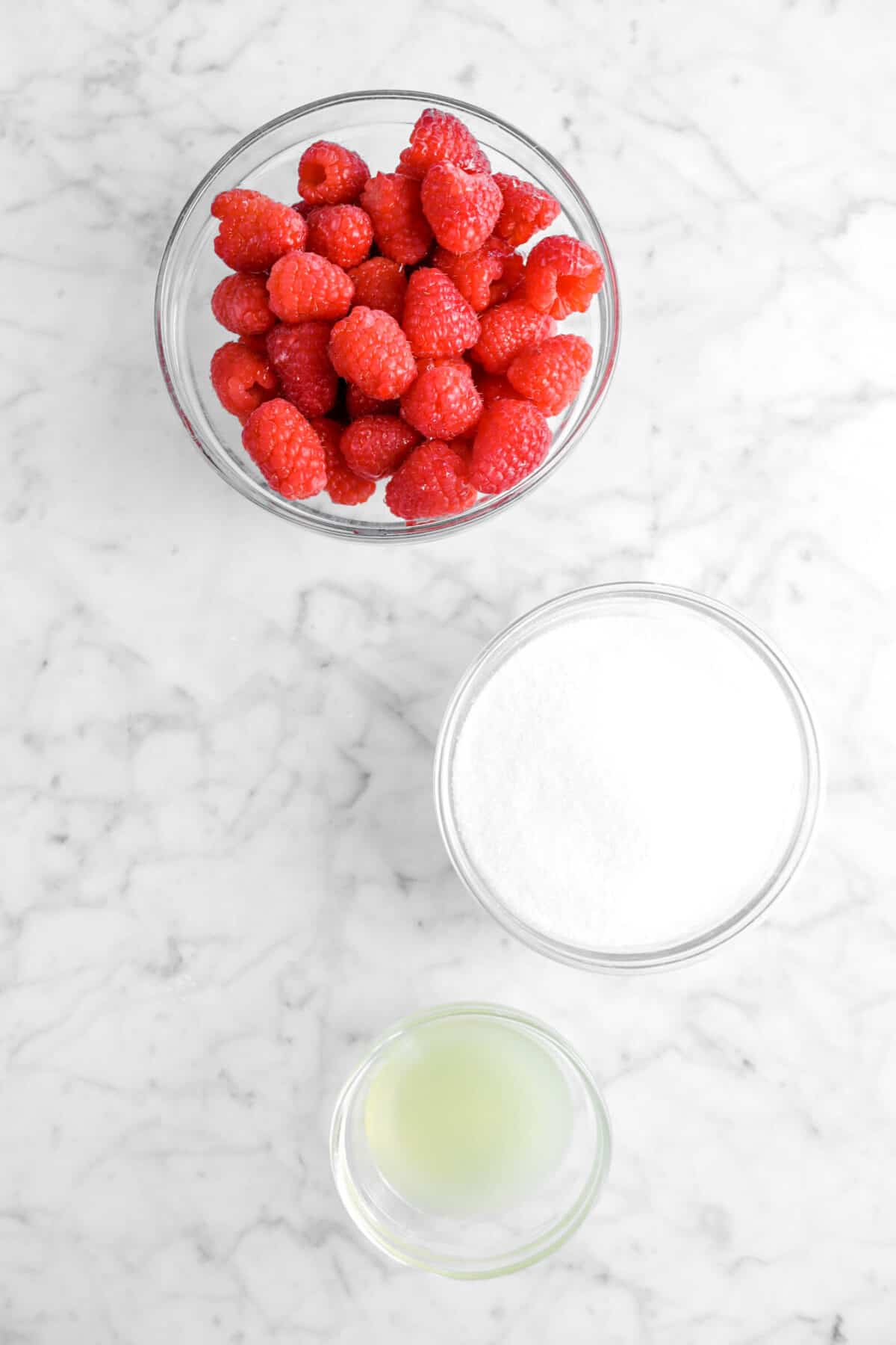 raspberries, sugar, and lemon juice in glass bowls