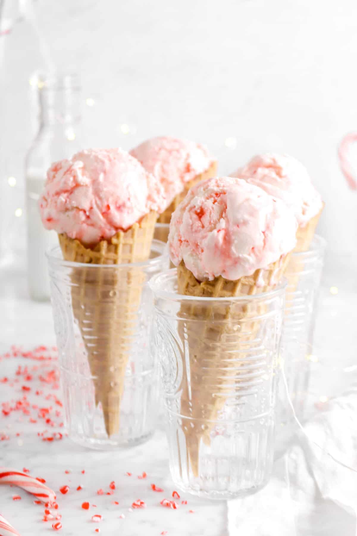 peppermint ice cream in four glasses with fairy lights