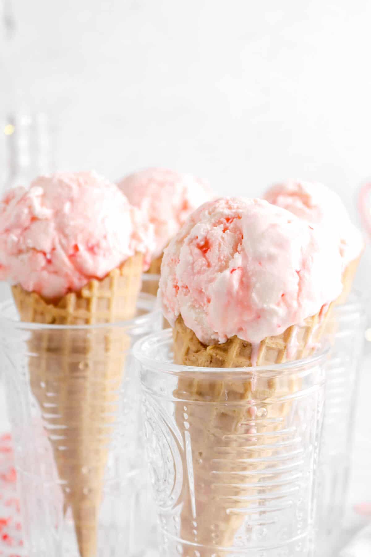 close up of peppermint ice cream on waffle cone in glasses
