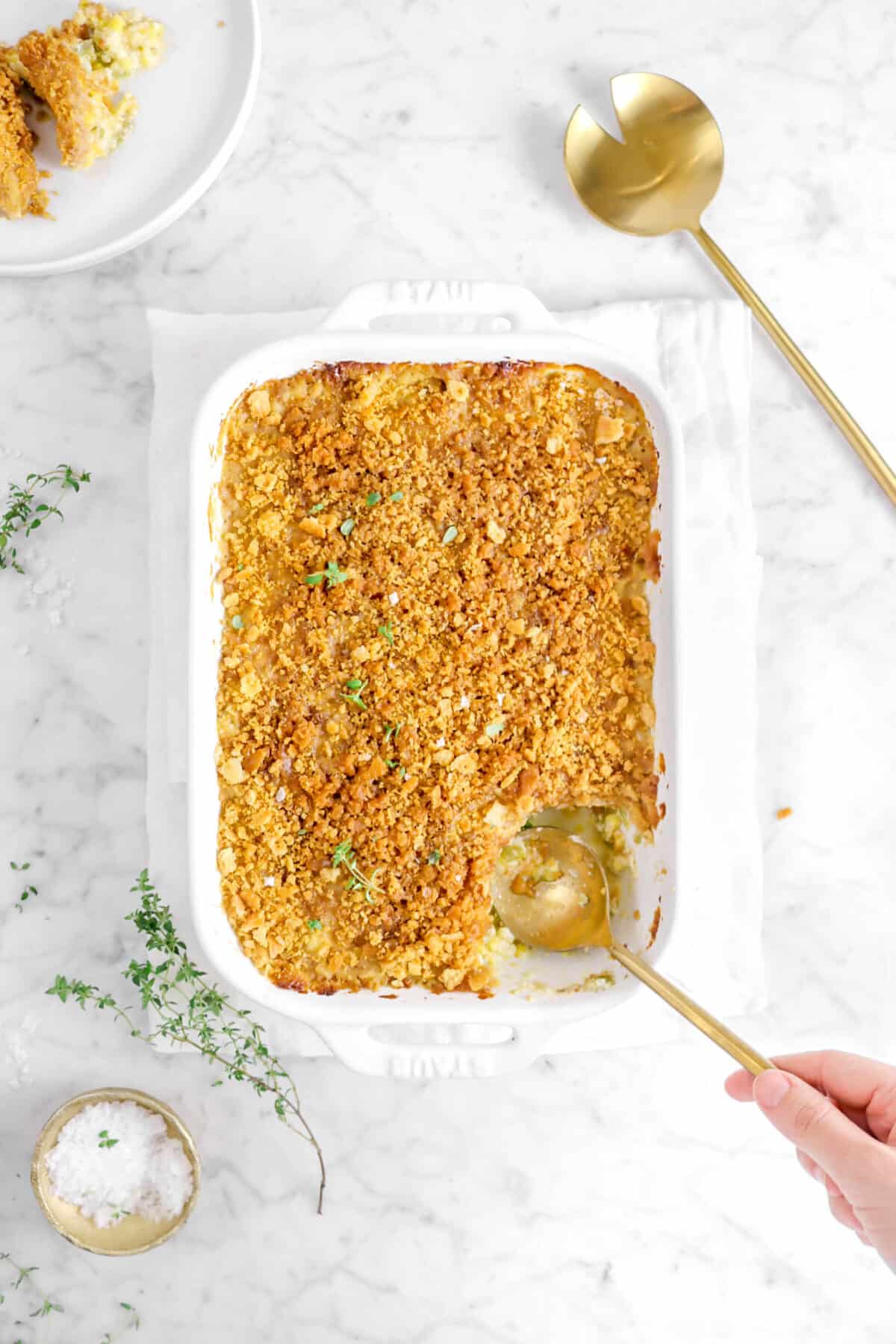 gold spoon digging out slice of shoepeg corn casserole